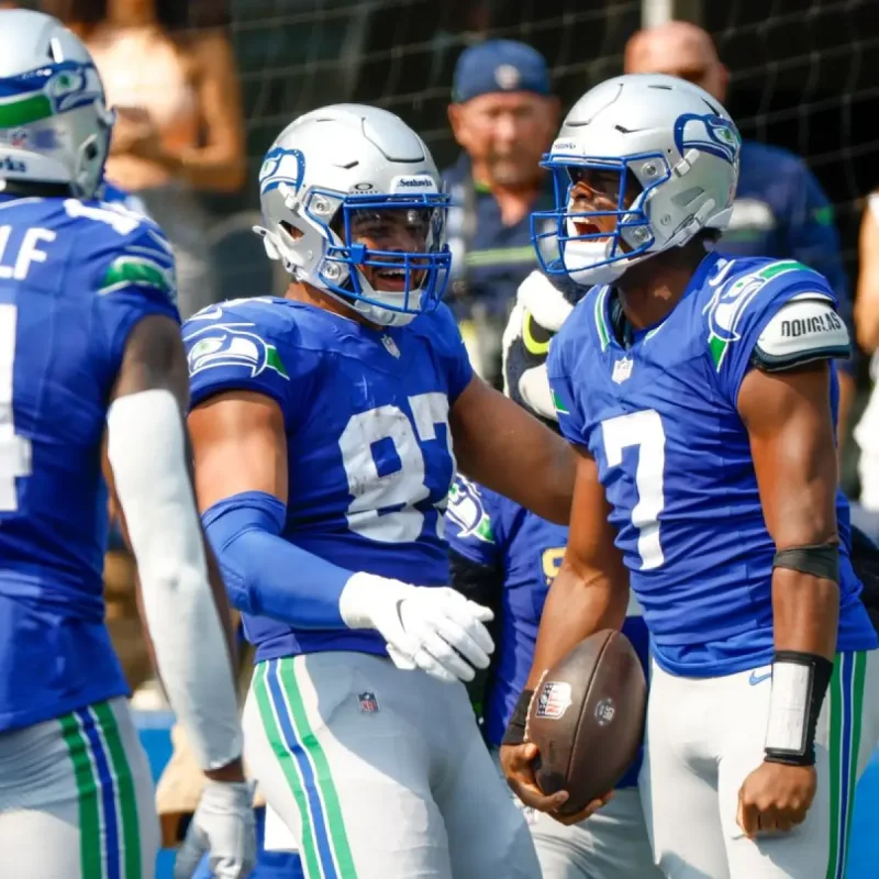 Denver Broncos and Seattle Seahawks players wearing throwback uniforms during an NFL game