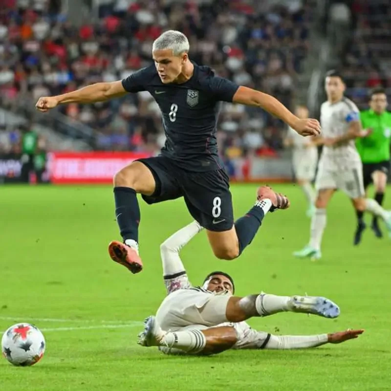 Smartphone showing a live sports results application with soccer scores